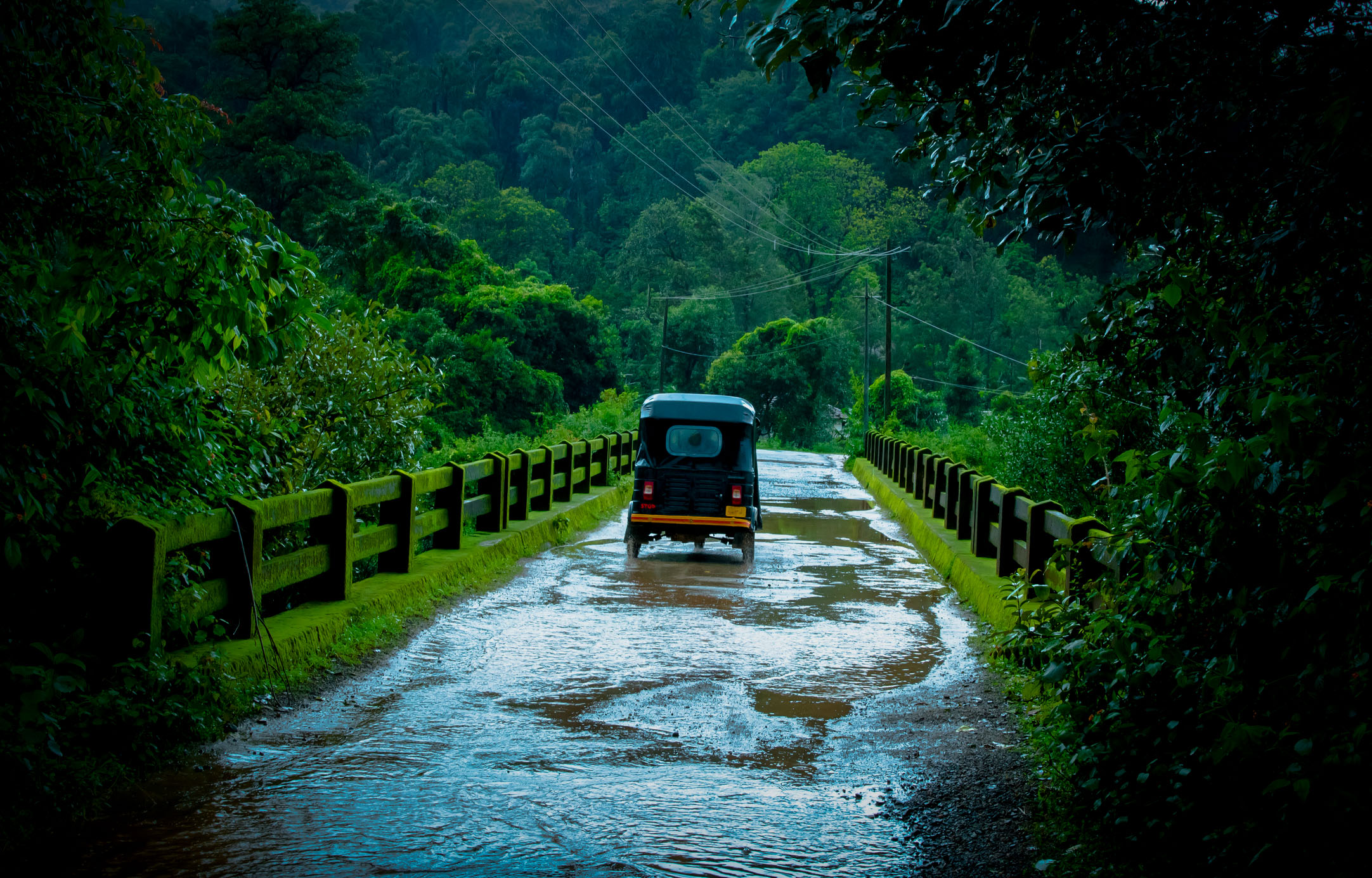 Tuk Tuk on road during monsoon rain